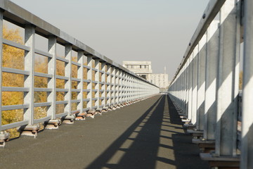 Unfinished bridge against the background of the silhouette of the city. Unfinished highway away city. Fender on the autobahn