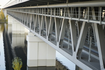 Unfinished bridge against the background of the silhouette of the city. Unfinished highway away city. Fender on the autobahn