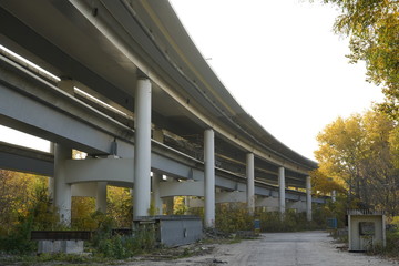 Unfinished bridge against the background of the silhouette of the city. Unfinished highway away city. Fender on the autobahn