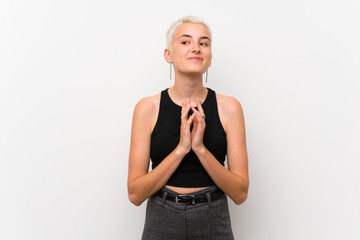 Teenager girl with short hair over white wall scheming something