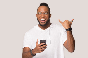 Happy biracial man in glasses amazed by smartphone news