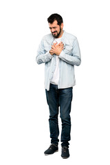 Fototapeta premium Full-length shot of Handsome man with beard having a pain in the heart over isolated white background
