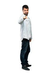 Fototapeta premium Full-length shot of Handsome man with beard points finger at you with a confident expression over isolated white background