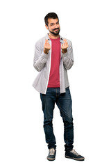 Fototapeta premium Full-length shot of Handsome man with beard making money gesture over isolated white background