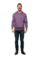 Fototapeta premium Full-length shot of Handsome man with sweatshirt shouting to the front with mouth wide open over isolated white background