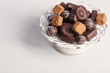 chocolate candy on plate on white table