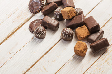 chocolate candy on white wooden background