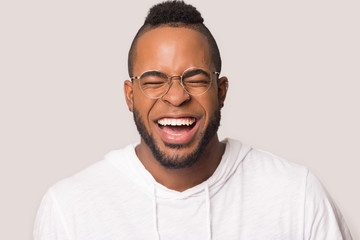 Headshot of overjoyed african American man laughing
