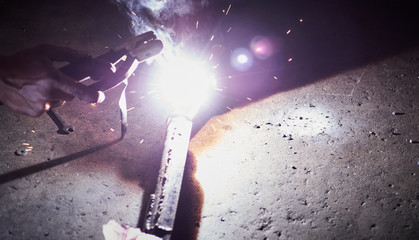 Blur Authentic close-up. Gas welding of metal parts during the work in garage. 