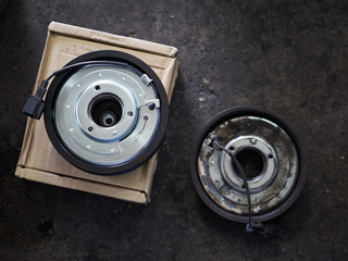 Naklejka premium New and Old clutch pad. Car part and air conditioner system concept. In the repair garage. 
