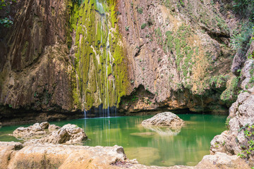 beautiful close up view of El Limon tropical waterfall with lots of moss and steaming water, front...