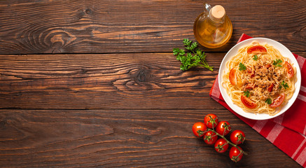 Pasta bolognese with tomato sauce and minced meat, grated parmesan cheese and fresh parsley - homemade healthy italian pasta on rustic wooden background. Flat lay. Top view.