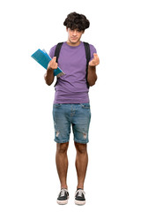 A full-length shot of a Young student man making money gesture over isolated white background