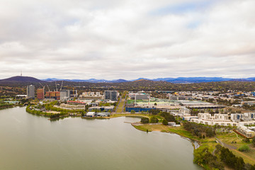Fototapeta na wymiar Aerial view of Belconnen town centre and Lake Ginninderra on a cloudy day in Canberra, the capital of Australia 