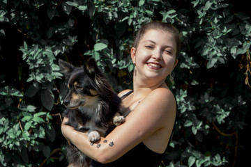 Obraz premium Portrait of happy young woman with her cute dog