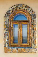 Arched wooden window in a wall
