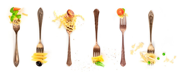 Italian food collage. Pasta design elements. Many forks with pasta and various addings, shot from above on a white background