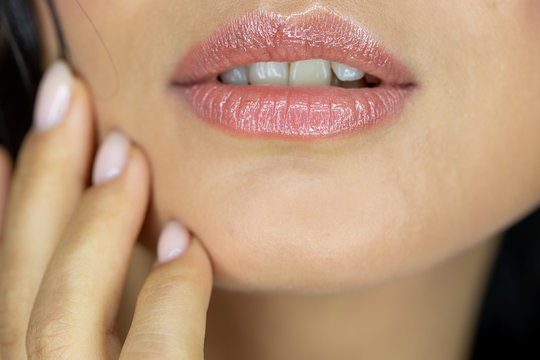 Close-up perfect natural lip makeup beautiful female mouth. Plump sexy full lips. Macro photo face detail