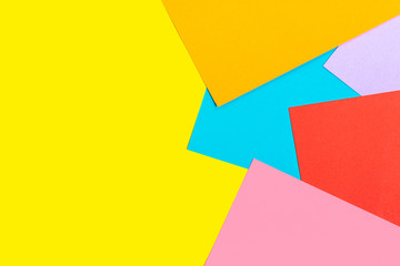 abstract geometric background of colored paper - yellow, red, blue, orange, lilac colors Flat lay Top view Mock up