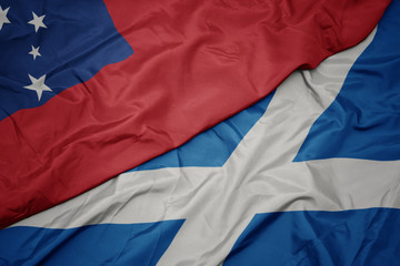waving colorful flag of scotland and national flag of Samoa .