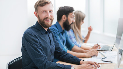 close up. successful business man sitting at the office table
