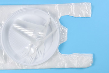 Plastic dishes on a blue background.  Disposable tableware