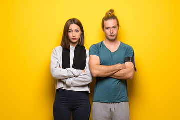 Obraz premium Group of athletes over yellow background portrait