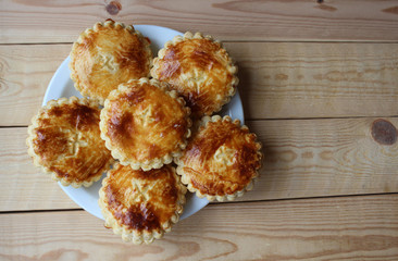 Flat lay view of a plate of freshly baked 'Mattentaart', a gastronic speciality of the Geraardsbergen region of Belgium. With copy space.