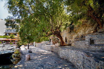 Ancient ruins on the shore of a fresh lake in Agios Nikolaos. Greece. Crete.