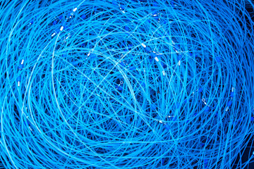 Fishing nylon. Abstract image of curves and loopes of blue plastic strings.