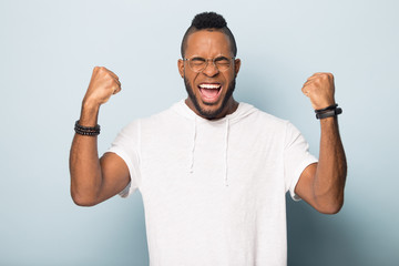 Overjoyed biracial male feel euphoric celebrating success