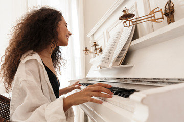 Lady in lingerie and white shirt play the piano