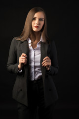 young beautiful brunette girl black background, portrait, straight long dark hair, black jacket, white blouse
