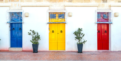 Blue, yellow and red wooden doors