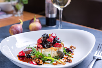 Grilled camembert cheese with berry salad.