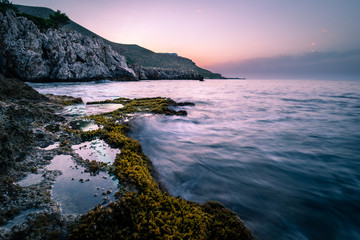 The sea at sunset from Italy, with some clouds on sky.