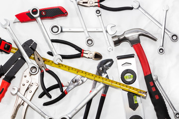 Working tools on a light background, hammer, wrench, ruler.