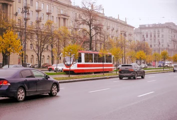 Foto op Canvas cars, tram on the road in St. Petersburg on an autumn cloudy day, traffic, buildings in the city center, trees with yellow leaves, October 2019, © Elena