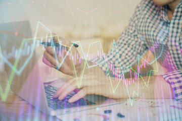 Multi exposure of forex graph with man working on computer on background. Concept of market analysis.