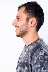 Fototapeta premium Closeup profile view of happy young bearded Persian man smiling