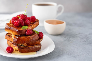 French toasts, French toasts made of sliced brioche with fresh raspberries, honey and mint. Delicious breakfast or dessert
