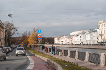 Fototapeta na wymiar river embankment in St. Petersburg, October 2019, old buildings, people on the street,