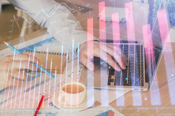 Forex graph with businessman working on computer in office on background. Concept of hardworking. Multi exposure.