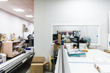 Work area in paper cutting workshop with material and machines