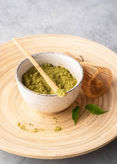 Japanese matcha green tea powder, a healthy natural product, antioxidant. Bamboo spoon and whisk.