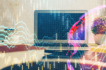 Financial chart drawing and table with computer on background. Double exposure. Concept of international markets.