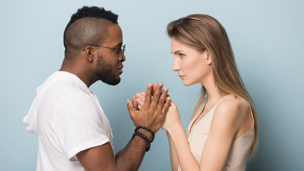 Multiethnic couple hold hands share intimate moment together