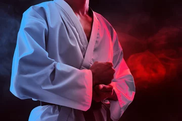 Rucksack Karate martial arts fighter on dark background © fotokitas