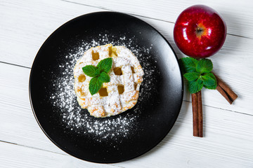 Homemade American Apple Pie Decorated with Powdered Sugar and Mint.