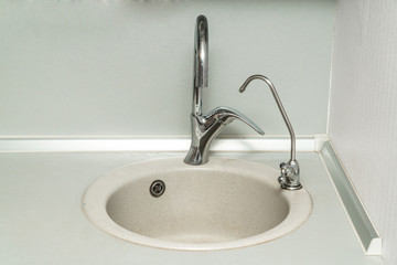 The photo of a sink in a The photo of a sink in a  kitchen